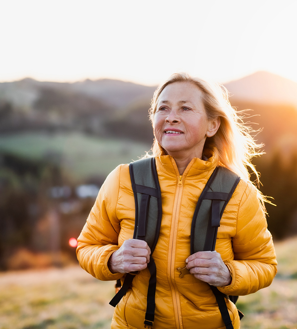 older woman smiling on hike